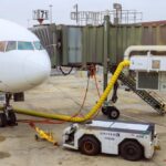 Airplane parked at the gate with boarding bridge and ground equipment