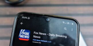 Smartphone displaying the Fox News app with ratings and download information