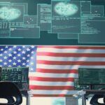 U.S. Unveils New Tough Cyber Defense Playbook A high-tech workspace featuring multiple computer monitors displaying data and an American flag in the background