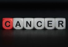 Blocks spelling the word 'CANCER' with one block in red