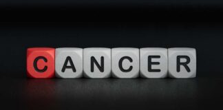 Blocks spelling the word 'CANCER' with one block in red