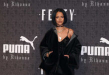 Rihanna posing at a fashion event with a Puma backdrop