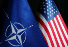 NATO flag and United States flag side by side.