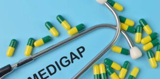 A stethoscope placed on a blue background with green and yellow capsules and the word 'Medigap'