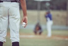 VIDEO: Major League Mayhem — Players Suspended A young baseball player holding a baseball while preparing to pitch