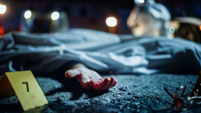 Crime scene with covered body and hand exposed.