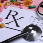 Prescription pad with various colorful pills and a stethoscope