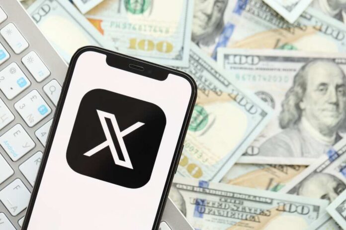 Smartphone displaying the X app logo on a background of cash