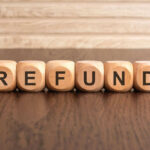 Wooden blocks spelling refund on table