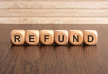 Wooden blocks spelling refund on table