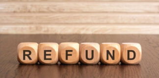 Wooden blocks spelling refund on table