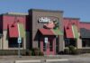 Exterior view of a Chili's restaurant with colorful awnings