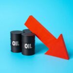 Three black oil barrels with the word 'OIL' and a red downward arrow