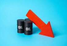 Three black oil barrels with the word 'OIL' and a red downward arrow