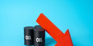 Three black oil barrels with the word 'OIL' and a red downward arrow