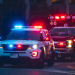 Bizarre Tragedy Kills Restaurant Diner Police car and ambulance with flashing lights nighttime