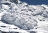 An avalanche cascading down a snowy mountain slope