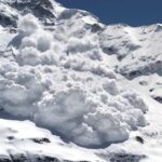 An avalanche cascading down a snowy mountain slope
