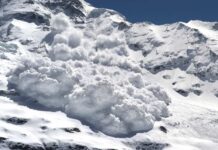 An avalanche cascading down a snowy mountain slope