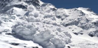 An avalanche cascading down a snowy mountain slope