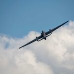 Military aircraft flying against a cloudy sky