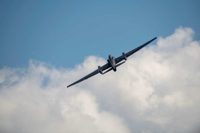 Military aircraft flying against a cloudy sky