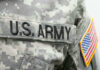 US Army uniform with American flag patch.