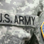 US Army uniform with American flag patch.