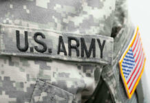 US Army uniform with American flag patch.