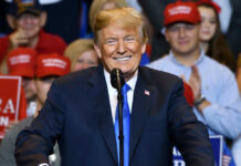 UPDATE: Trump Bets Big on Coal – MAGA Cheers Donald Trump speaking at a rally, supporters in background.