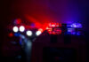 Domestic Call Erupts Into Deadly Shootout Police car lights shining in the dark.