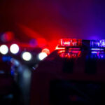 Domestic Call Erupts Into Deadly Shootout Police car lights shining in the dark.