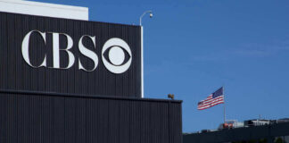 CBS building with American flag in background.