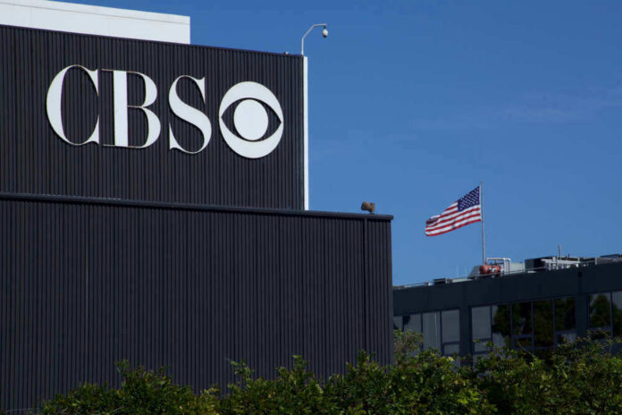 CBS building with American flag in background.
