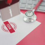 FDA warning stamp near stethoscope and keyboard