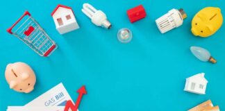 Household bills, piggy banks, and energy items on blue background