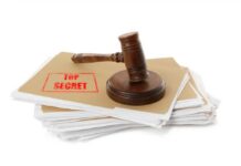 Judge’s gavel resting on a stack of confidential files