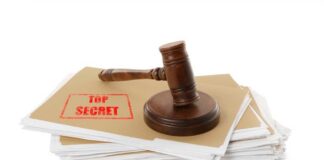 Judge’s gavel resting on a stack of confidential files