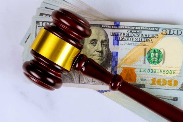 Judge’s gavel on a stack of U.S. hundred-dollar bills