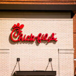 Chick-fil-A restaurant sign on a brick wall