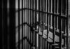 LOCK HIM UP! Hidden Knife, One Teen Dead Black and white prison cell bars in dim light.