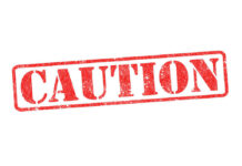 Stuck Switch Sends Seats Sliding — Recall Red caution sign with grunge texture diagonal