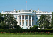 Historic Baby Stuns D.C. The White House, front view with fountain and flag.