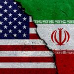 A cracked surface displaying the flags of the USA and Iran