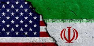 A cracked surface displaying the flags of the USA and Iran