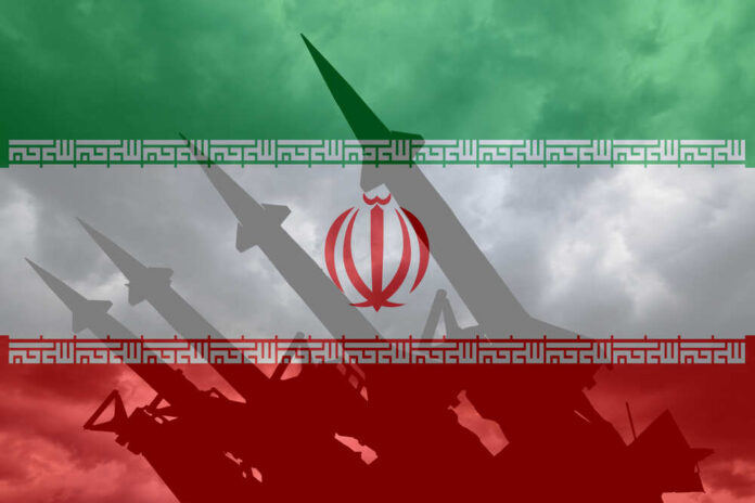 Silhouette of missiles in front of the Iranian flag