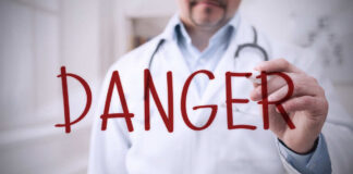 Blurred hospital corridor with medical staff walking