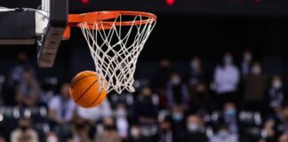 Basketball swishing through a hoop during a game