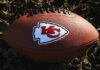 Kansas City Chiefs football lying on the grass.