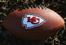 Kansas City Chiefs football lying on the grass.